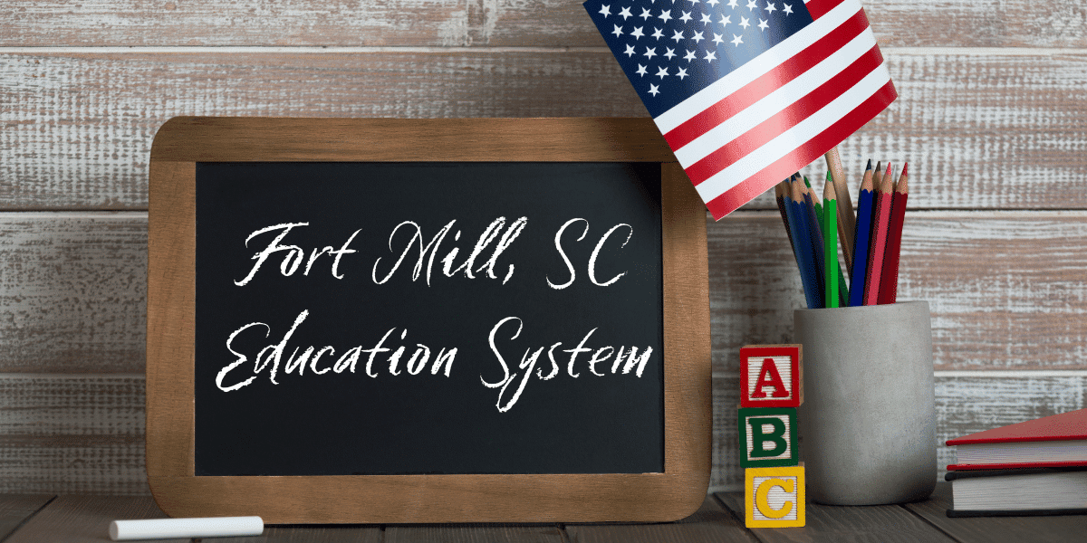 Small chalkboard in a classroom with "Fort Mill, SC Education System written on it.
